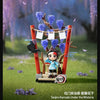 Collectible blind box figures of Tanjiro Kamado under the Wisteria, featuring a character in a blue outfit surrounded by purp