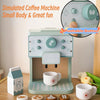 A simulated coffee machine toy with a small body and pushable button, surrounded by cups and accessories.