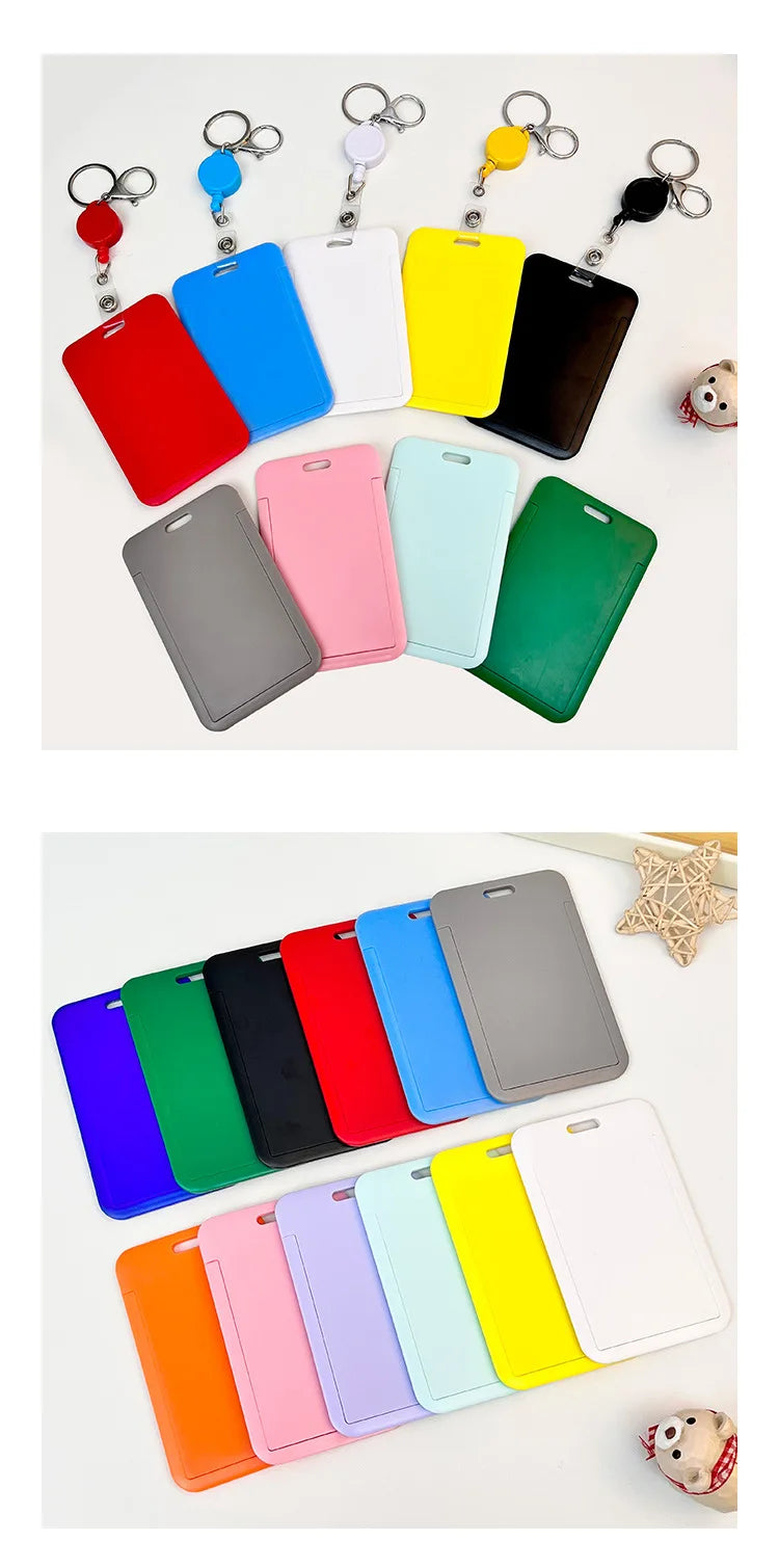 A collection of colorful retractable ID badge holders with keychains and clips arranged on a white background.