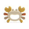 A silicone baby teether shaped like a crab, featuring yellow and beige parts for soothing gums.