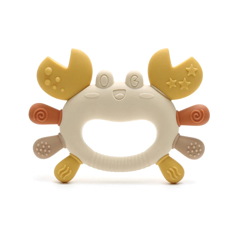 A silicone baby teether shaped like a crab, featuring yellow and beige parts for soothing gums.