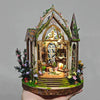 A detailed diorama of a gothic wooden book nook featuring floral elements and an illuminated scene.