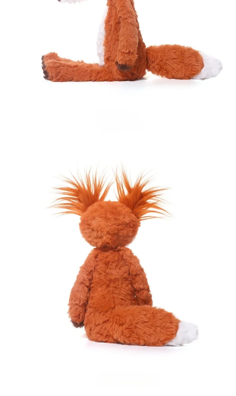 An orange fox plushie with white accents, shown in a close-up view.