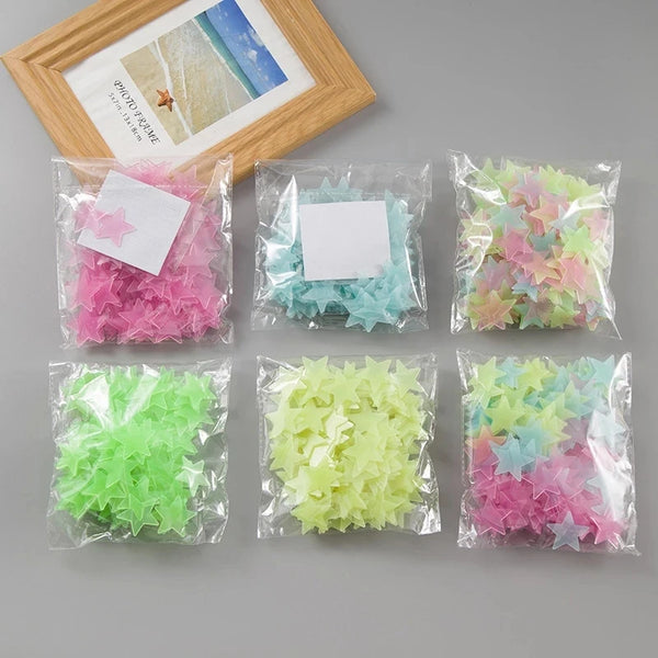 Assortment of glow-in-the-dark 3D star wall decor stickers in various colors packaged in plastic bags.