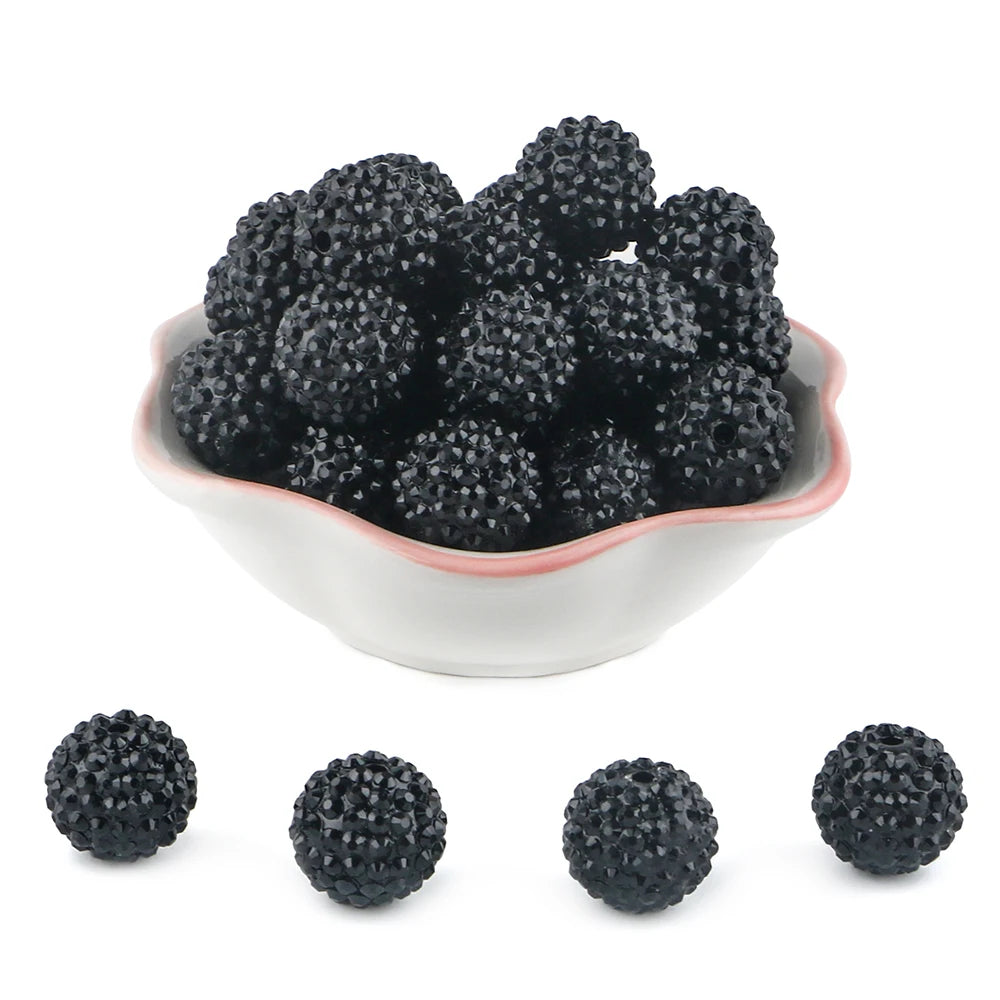A pile of black rhinestone resin bayberry beads for jewelry making