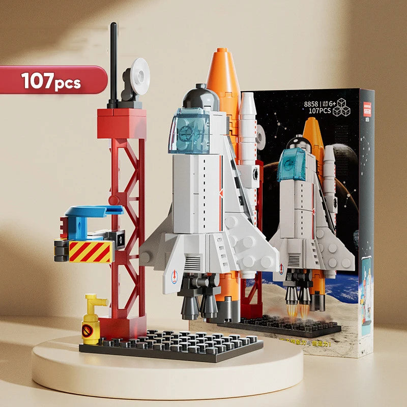 A 107-piece space rocket building blocks set featuring a launch center and rockets displayed next to its box.