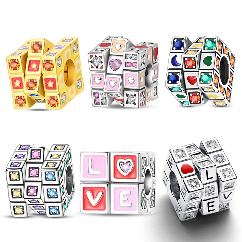 A collection of 925 sterling silver rotatable Rubik's cube charms in various colors and designs.