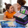 Two women enjoy a DIY activity together, holding an open diamond art storage container with colorful trays and tools.
