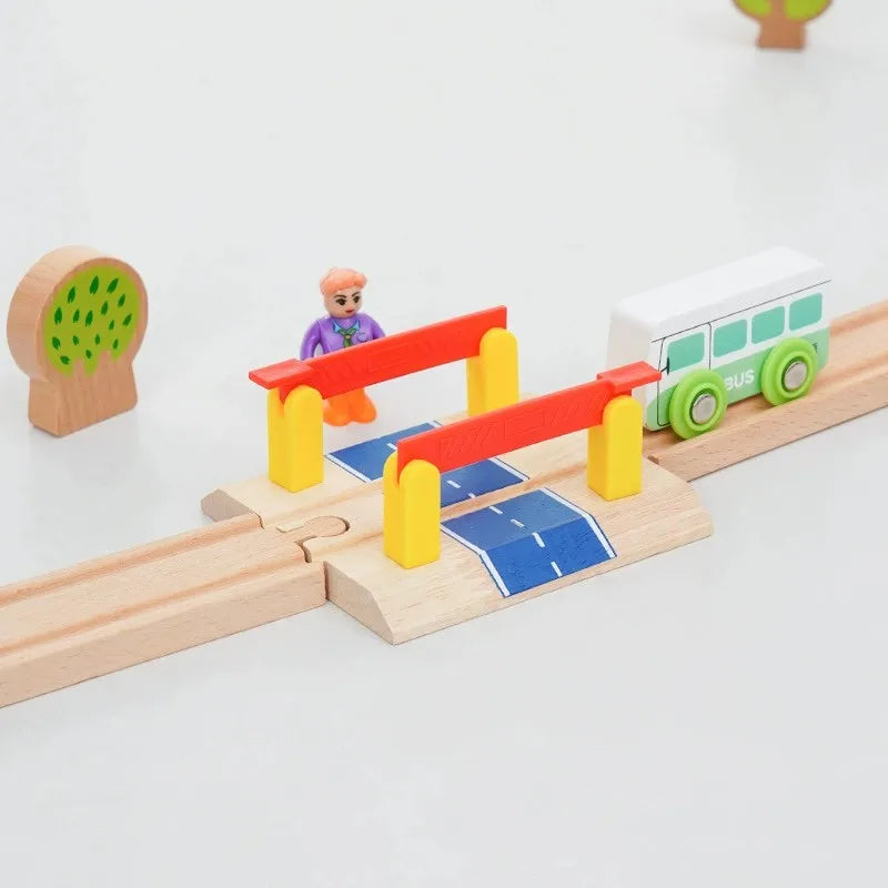 A wooden train track accessory set featuring a red bridge, yellow supports, and a green train on a light wood surface.