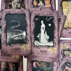 A collection of purple-toned oracle cards featuring black and white illustrations of serpents, figures, and masks.