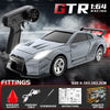 GTR 1:64 Racing car model with a remote control and various fittings displayed on a dark background