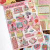 A page from a vintage embroidery sticker book featuring various cute, pastel-colored embroidered stickers for journaling.