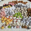 A large collection of handcrafted crochet animal keychains in various colors and styles.