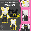 A detailed view of a black and white striped bear figure made from micro building blocks, displayed against a pink background