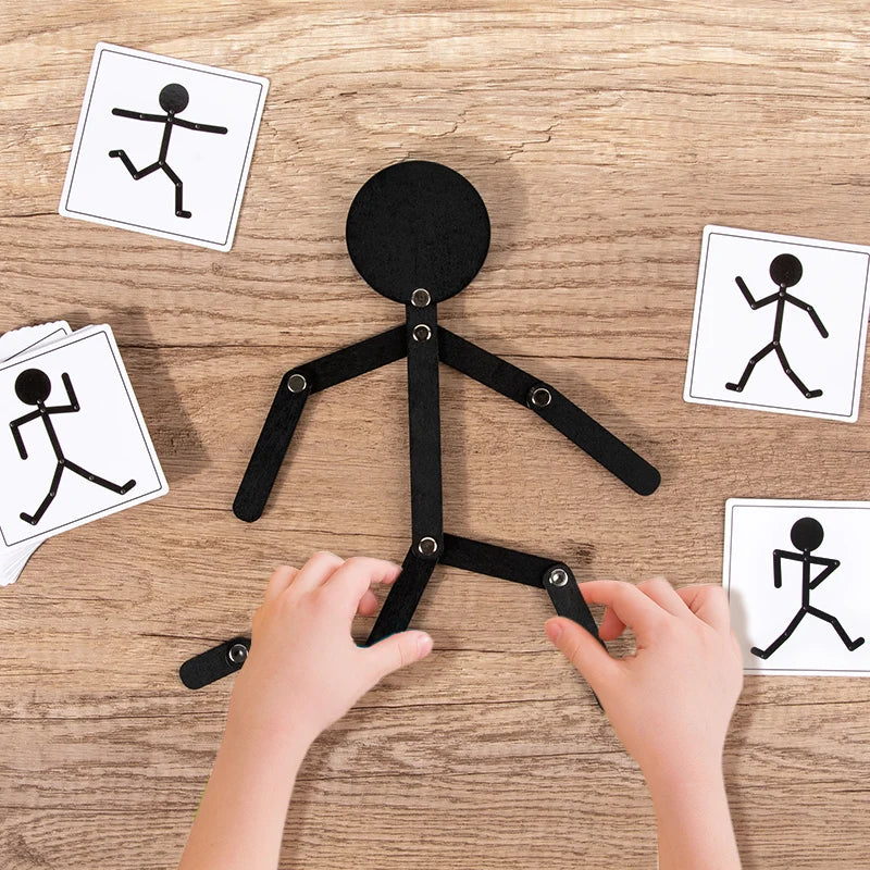 Hands assembling a black wooden sports pose jigsaw puzzle for children on a wooden surface.