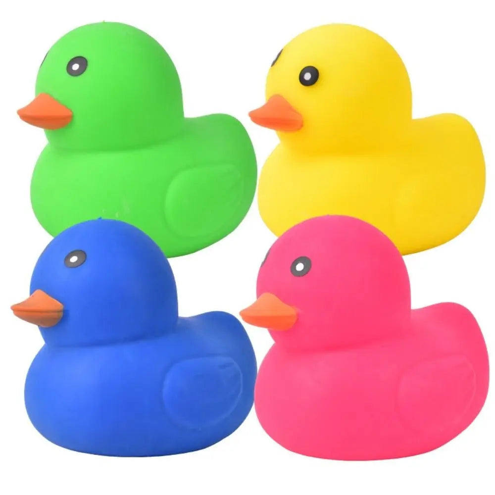 Three plastic duck toys in green, yellow, and pink are shown side by side.