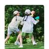 Two children are playing outdoors with a pull-string flying saucer launcher toy.