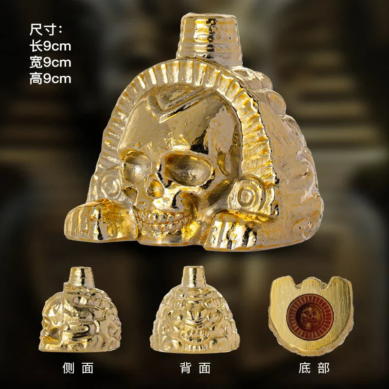 Gold handcrafted Aztec death whistle shown from the front, back, and side views.