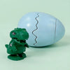 A green wind-up bouncing chick toy is shown cracked open, revealing the interior.