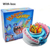 A box and a plastic shark-themed prank board game with various colored teeth and parts.