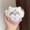 A fluffy white plush keychain set featuring three cute animal characters with pastel accents.