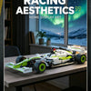 A detailed 1:8 scale formula racing car model with green and white livery displayed on a wooden table.