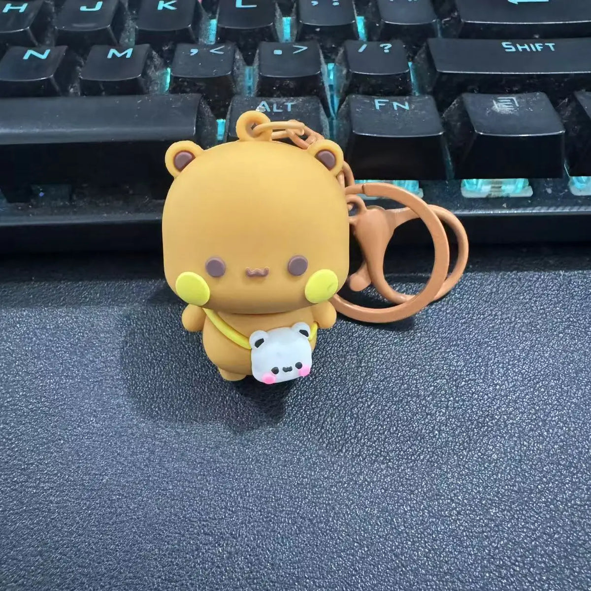 A cute cartoon bear couple keychain set featuring a large orange bear and a small white bear.