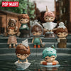 A collection of POP MART Hirono Small Mischievous series blind box figures displayed on a stone surface.