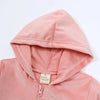 A pink kids velvet tracksuit set featuring a hooded zipper coat and matching pants.