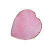 A heart-shaped piece of pink resin with a gold trim.