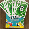 A deck of green and white matching cards is shown next to a box for the FLIP! Fast-Paced Matching Card Game.