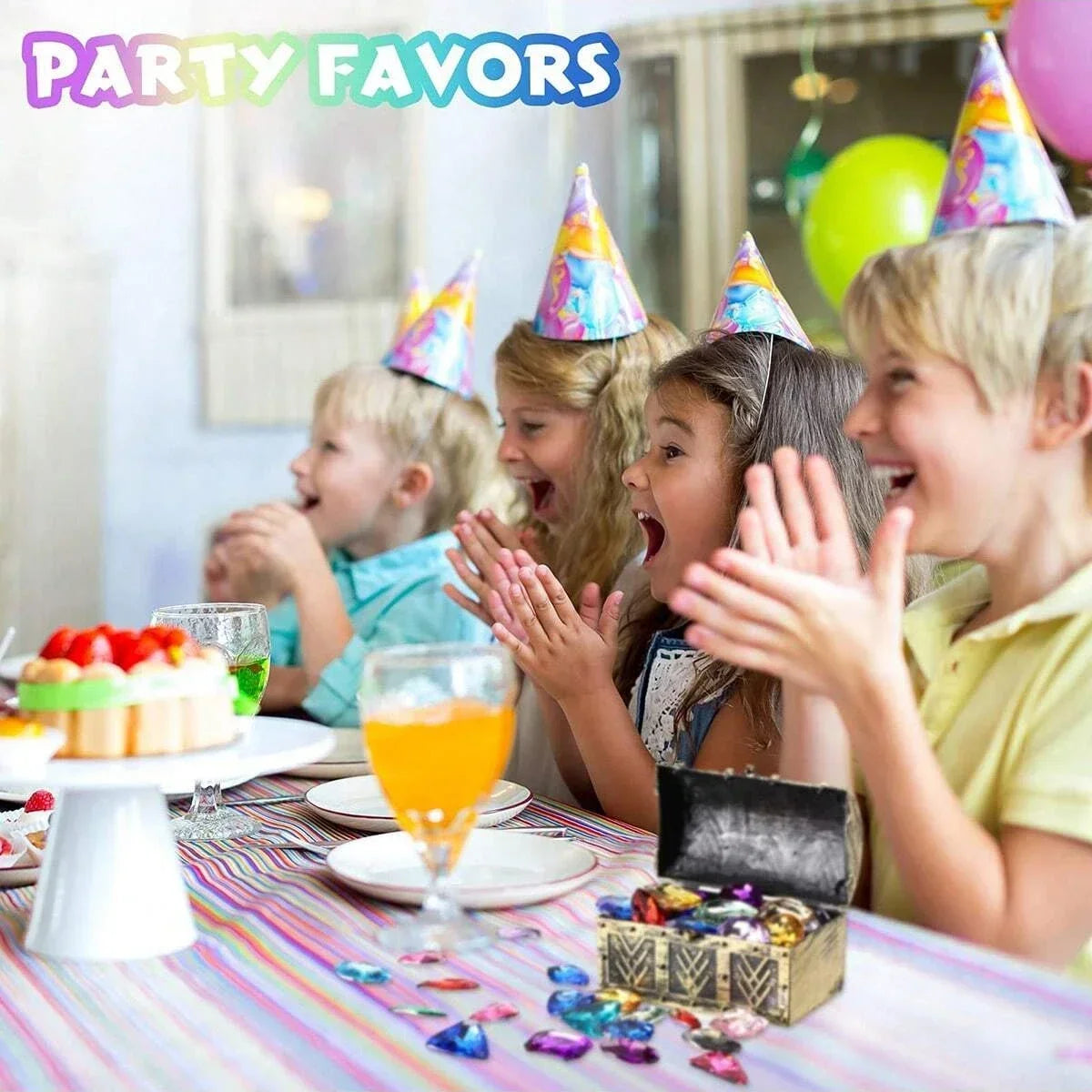 Children laughing and interacting with pirate treasure gemstones on a table during a party.