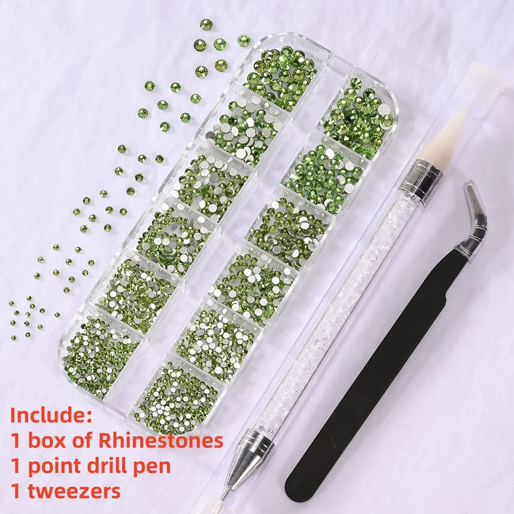 A box of green rhinestones, a point drill pen, and tweezers are displayed on a white background.