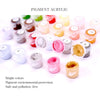 A collection of pigment acrylic paint pots in various bright colors arranged on a white background.