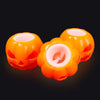Two bright orange squishy fidget toys shaped like pumpkins with pink interiors