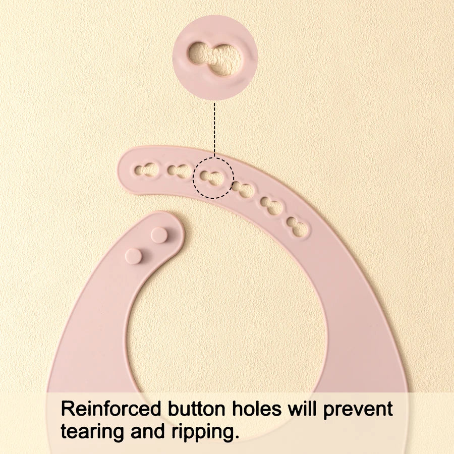 Pink silicone baby bibs showing reinforced button holes for durability