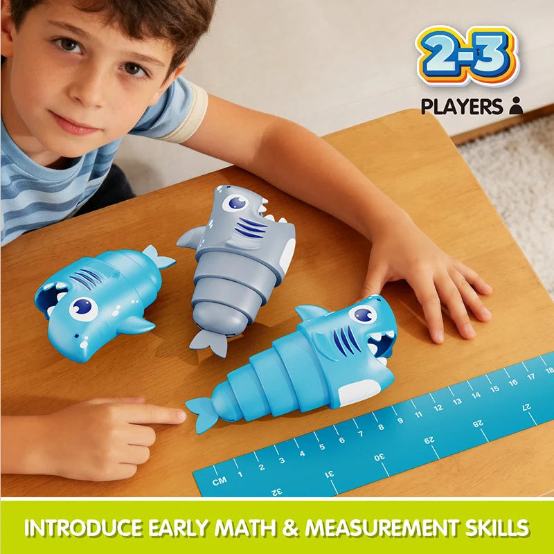 A child points to a blue plastic shark toy in a set of 8 for early math and measurement skills.