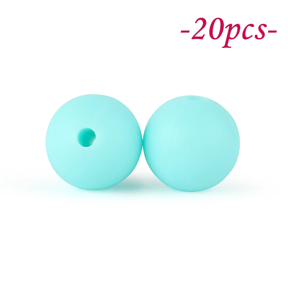 Two light blue silicone beads are shown against a white background.