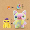 A large, fluffy yellow and pink monster plush toy with large eyes and teeth is shown next to a small rabbit-themed keychain.
