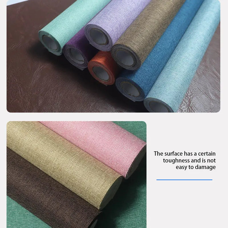 Rolls of linen book binding cloth in various shades of green, purple, and blue fabric.