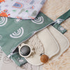 Two reusable waterproof baby wet bags featuring colorful rainbow patterns and natural fabric on a light background.