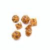 A collection of seven small, amber-colored polyhedral dice scattered on a white background.