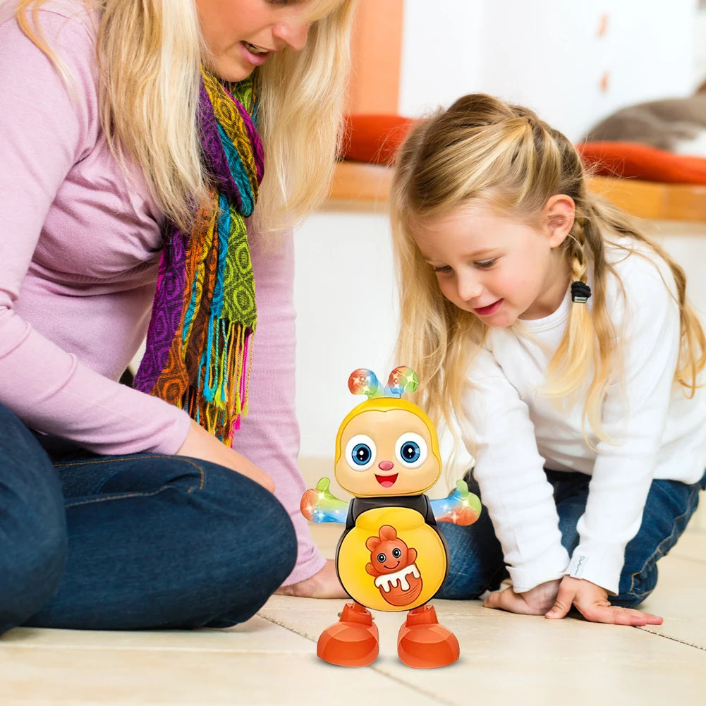 A young girl is interacting with an electric dancing bee musical toy on the floor.