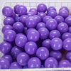 A bulk set of purple plastic ocean ball pit toys in a white basket.
