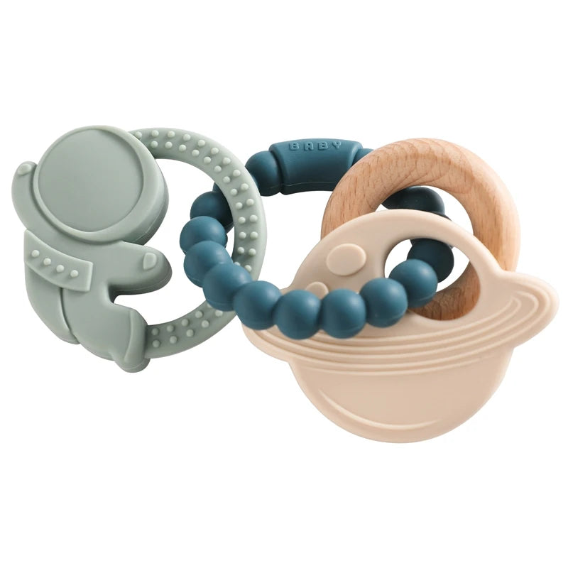 Food-grade silicone planet teether for babies in shades of green, blue, and natural wood tones
