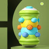 A colorful Montessori baby crawling roller toy with multiple textured spheres in shades of green, yellow, and blue.