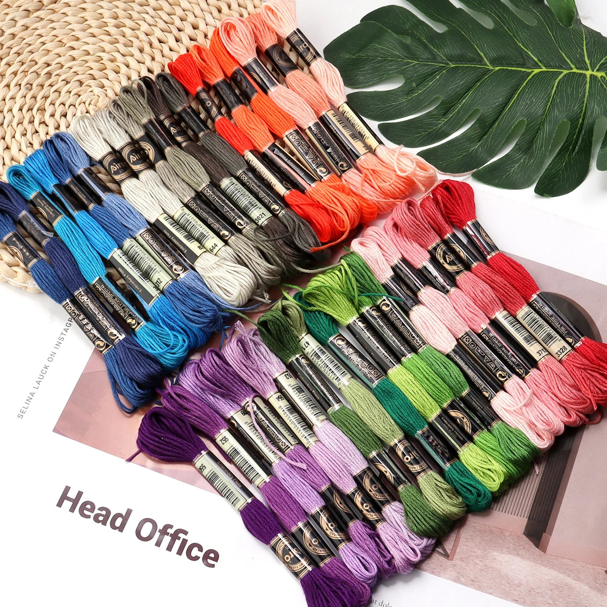 A collection of vibrant embroidery thread skeins in various colors and shades arranged for cross stitch and DIY crafts.
