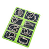 A green puzzle board containing various metal wire puzzles and brain teasers.