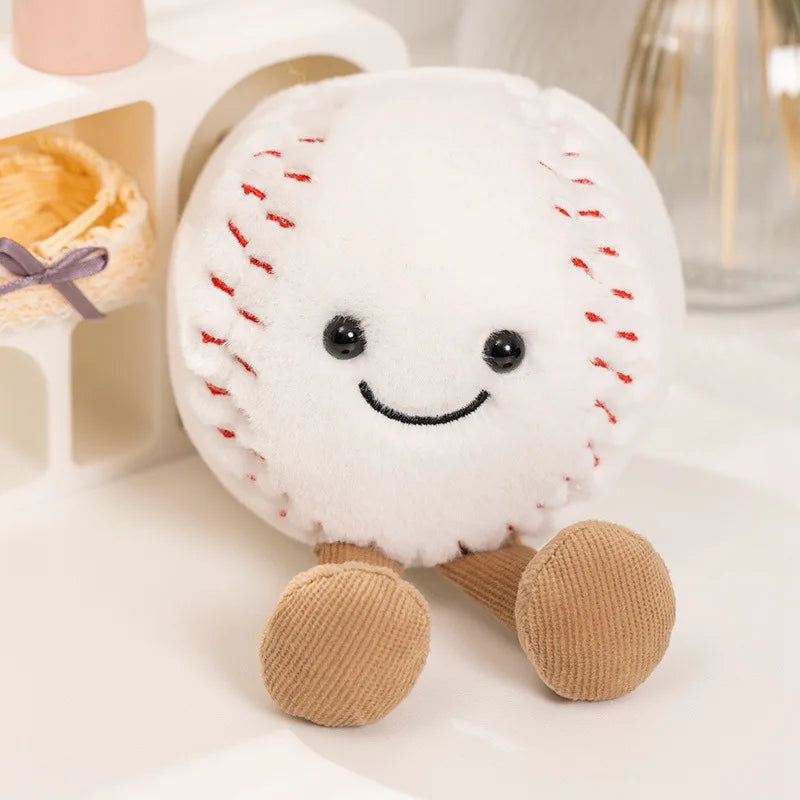 A white plush doll resembling a baseball, complete with stitched red seams and tan feet.