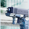 A blue high-power water blaster gun is shown spraying water in an outdoor setting.